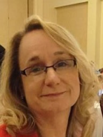 Headshot of Yvonne Wright, a white woman with blond hair and glasses