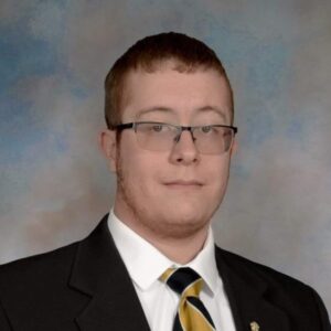 Professional headshot of Mark Shepard, wearing a suit and tie