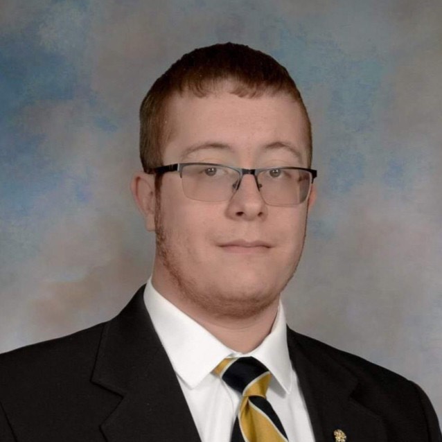 Professional headshot of Mark Shepard, wearing a suit and tie